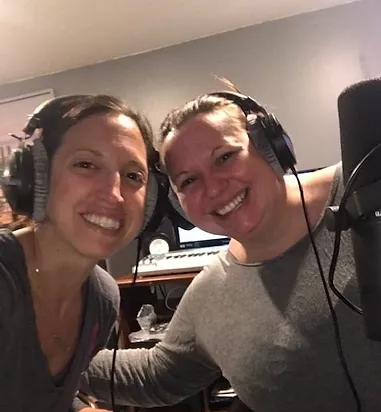 Lori and Melissa in studio, wearing headphones.